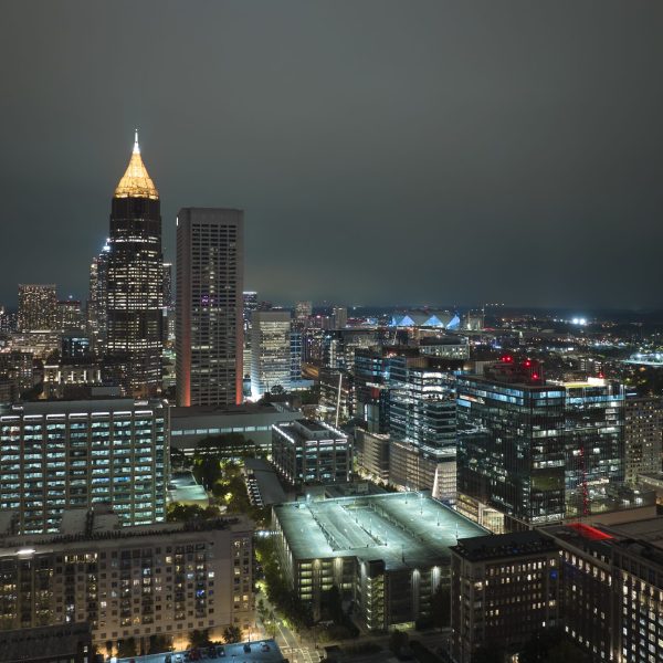 View from above of brightly illuminated high skyscraper buildings in downtown district of Atlanta city in Georgia, USA. American megapolis with business financial district at night.